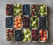 Summer fruit and berry variety. Flat-lay of strawberries, cherries, grapes, blueberries, pears, apricots, figs in wooden eco-friendly boxes over grey background, top view. Local farmers produce