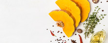 Slices Of Ripe Pumpkin With Spices And Olive Oil. Autumn Food Concept. Banner For Site