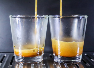 Close-up of espresso pouring from coffee machine. Professional coffee brewing