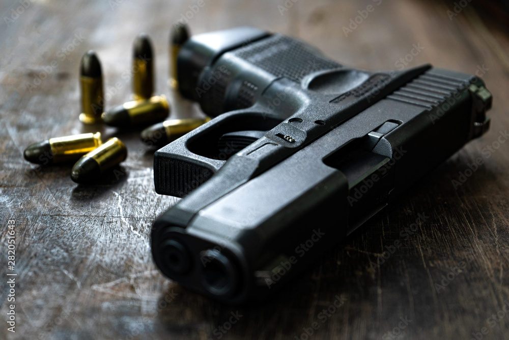 Guns and ammunition on the wooden table, top view and free space for ...