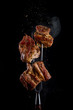 © mars58 - Fork with pieces of delicious barbecued meat on black