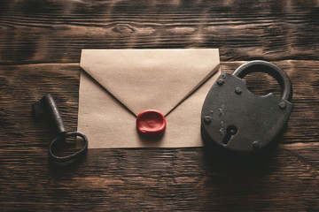 Wall Mural - top secret documents in envelope, rusty padlock and a key on a wooden table flat lay background. con