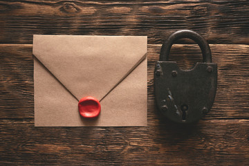 Wall Mural - top secret documents in envelope, rusty padlock and a key on a wooden table flat lay background. con