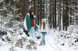 © alexkich - Young family for a walk. Mom and daughter are walking in a winter park.