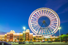Theme Park With Ferris Wheel In Taichung At Dusk
