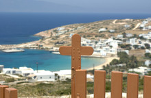 Greece, The Island Of Donoussa.  A Gate To A Church On A Hill Above The Port Of Stavros.  The Gate Is In Focus, The View Is To The Town, Which Is Blurred.