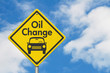 © Karen Roach - Oil change with car on yellow warning highway road sign