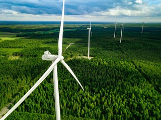 aerial view of windmills in summer forest in finland. wind turbines for electric power with clean an