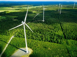 aerial view of windmills in summer forest in finland. wind turbines for electric power with clean an