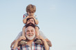 © Volodymyr - Happy fathers day. Father and son enjoying outdoor. Men generation: grandfather father and grandson are hugging looking at camera and smiling.