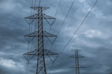 high voltage tower on background of blue sky