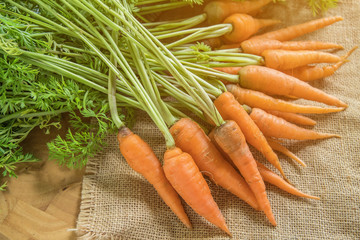 Wall Mural - Fresh and sweet carrot on wooden table