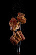 © mars58 - Fork with pieces of delicious barbecued meat on black