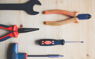 Tools on wooden background, top view