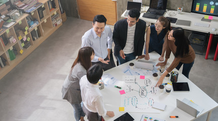 Wall Mural - Group of Asian business people team meeting in modern office working design planning and ideas concept