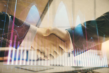 Multi exposure of financial graph on office background with two businessmen handshake. Concept of success in business