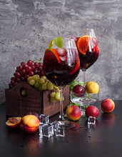 Sangria Red Wine Or Punch With Fruit And Ice In Glasses. Homemade Refreshing Sangria Fruit On A Rustic Wooden Table. Spanish Cuisine.
