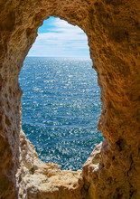 Looking Out To Sea Through A Hole In The Wall Of A Limestone Cave