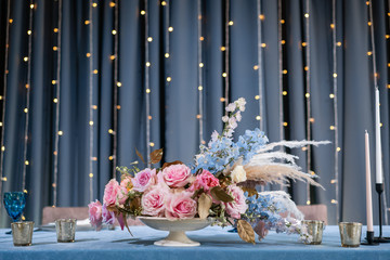 luxury dinner Banquet in the restaurant. Beautiful and exquisite decoration of the wedding celebration. Banquet served table with a beige pink tablecloth, plates and candlesticks with candles.