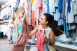 © JackF - young woman and girl in clothes store.