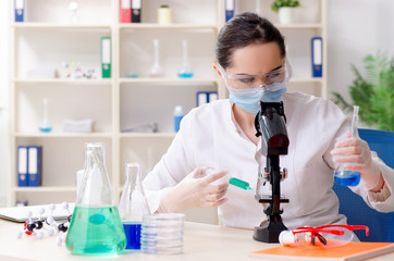 Young female chemist working in the lab