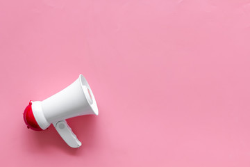 Attract attention with megaphone on pink background top view copyspace