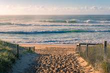Entrance To The Beach With Beautiful Waves At Sunrise