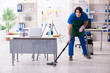 © Elnur - Male handsome professional cleaner working in the office