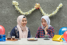 Two Hijab Bestfriend Preparing Birthday Surprise Party Sitting Together At The Concrete Table