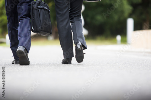 歩くビジネスマンとビジネスウーマンの足元 Stock Photo Adobe Stock