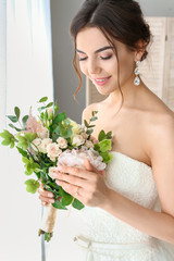 Canvas Print - Beautiful young bride with bouquet of flowers at home