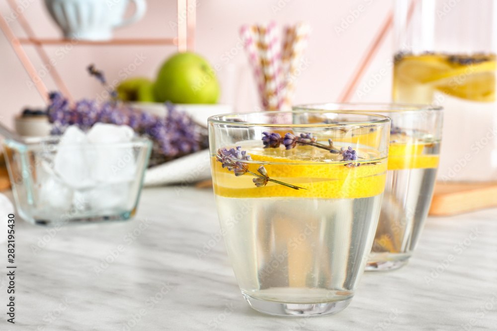 Glasses of tasty infused water on light table