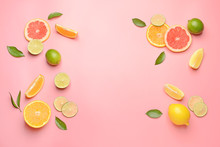 Different Sliced Citrus Fruits On Color Background