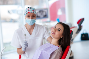 Wall Mural - Portrait of a dentist and a beautiful girl in dentistry.