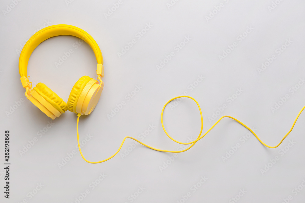 Modern headphones on light background