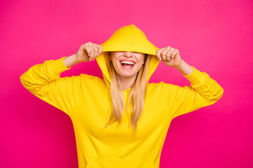 Closeup photo of nice lady hiding eyes with hood wear yellow hoodie pullover isolated pink background