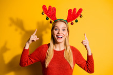 Close-up Portrait Of Her She Nice Lovely Attractive Charming Cute Cheerful Cheery Girl Wearing Festal Look Pointing Two Forefingers Up At Red Horns Isolated Over Bright Vivid Shine Yellow Background