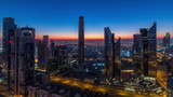 Fototapeta Nowy Jork - Dubai downtown skyline with tallest skyscrapers and traffic on highway night to day timelapse