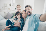 Fototapeta  - Photo of family two children making selfies weekend great mood sticking tongue out mouth best friends