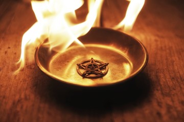 Old pentagram burning in flames