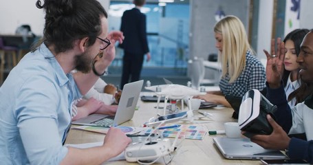 Young multiethnic business team of software developers working together using