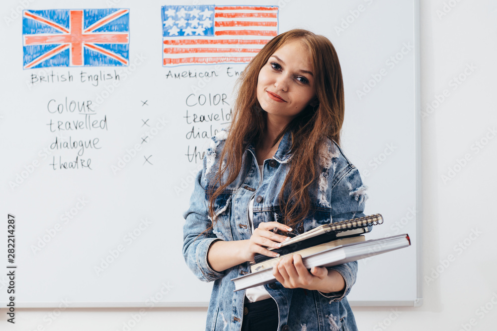 Female student looking at camera. English language school. - obrazy, fototapety, plakaty 