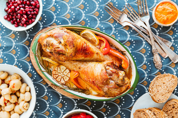 Wall Mural - Festive dish for Thanksgiving, roasted turkey legs with vegetables on a table with snacks. Top view, flat lay.