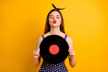 Sticker - Portrait of her she nice-looking attractive lovely winsome cheerful cheery dreamy straight-haired lady holding in hands round disc sending you kiss isolated on bright vivid shine yellow background