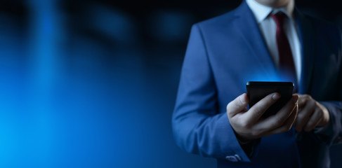 Wall Mural - Businessman holding smartphone. Man using phone in office