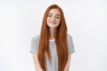 Wall Mural - Waist-up shot dreamy romantic charming smiling relaxed redhead girl closed eyes tender delighted smile imagine perfect lovely moment daydreaming making wish recalling nice memory, white background