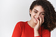© Cookie Studio - Cute tender romantic young hispanic attractive girl chuckling coquettish cover smile palm grinning have fun flirting sassy look camera standing amused entertained white background