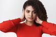© Cookie Studio - Close-up serious-looking fed up young female femenist unwilling hear violation human rights close ears palm look ignorant careless refuse lsiten standing white background unemotive