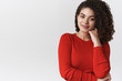 © Cookie Studio - Stylish sensual good-looking woman dark curly hairstyle smiling look confident flirty touch face gently grinning cheeky coquettish cross hand around arm, standing white background