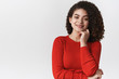 © Cookie Studio - Close-up powerful confident good-looking smiling creative young female entrepreneur dark curly hairstyle touch face smirking joyfuly have interest look curious standing white background